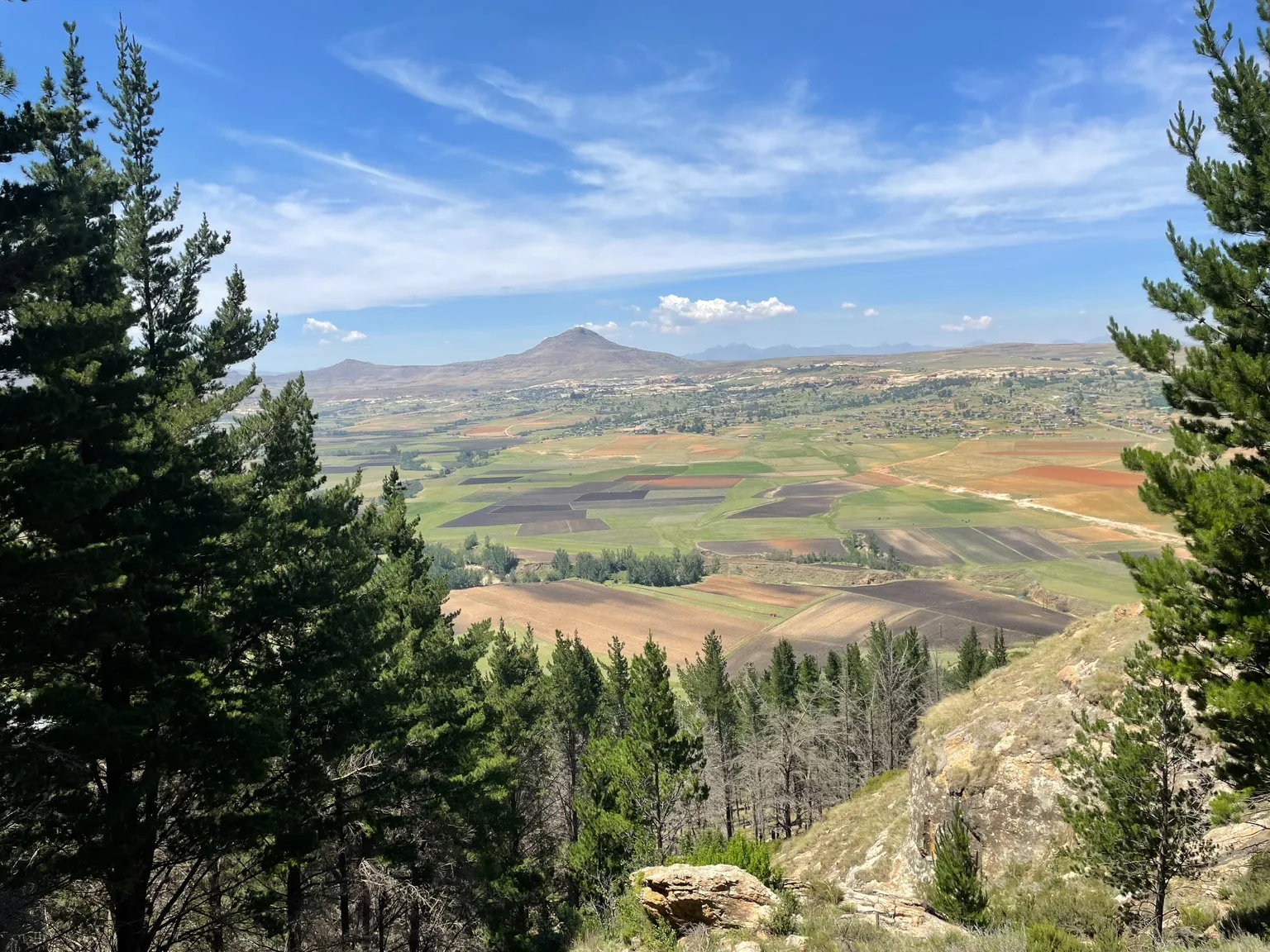Fields, green hills, and a mountain viewed from Dr. Alina’s home village